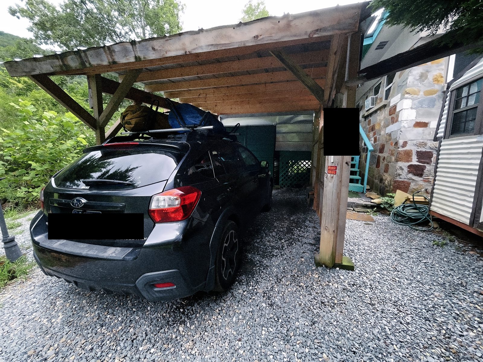 Subaru Crosstrek loaded with gear under a carport
