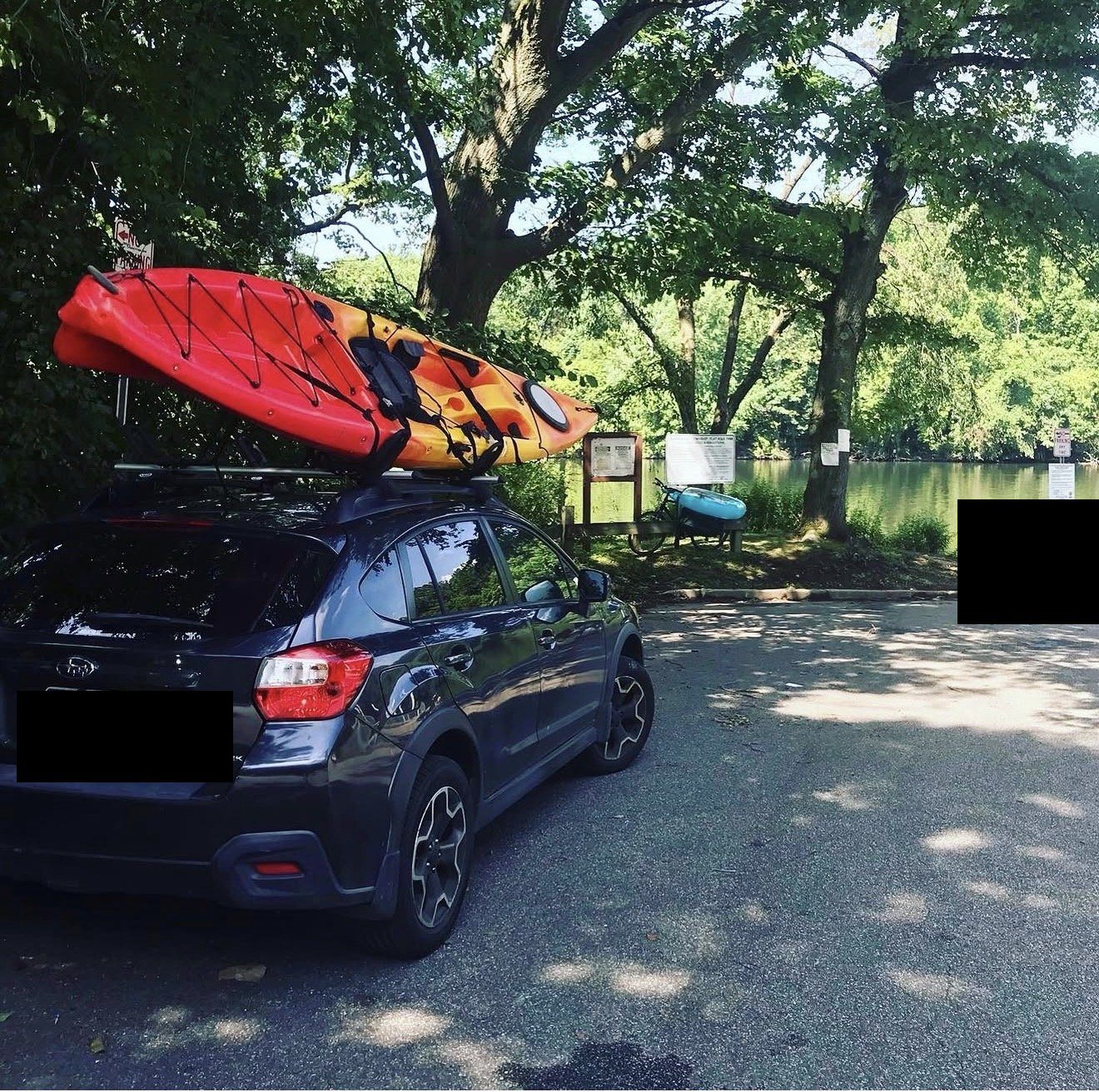 Subaru Crosstrek with kayak at a lake put-in