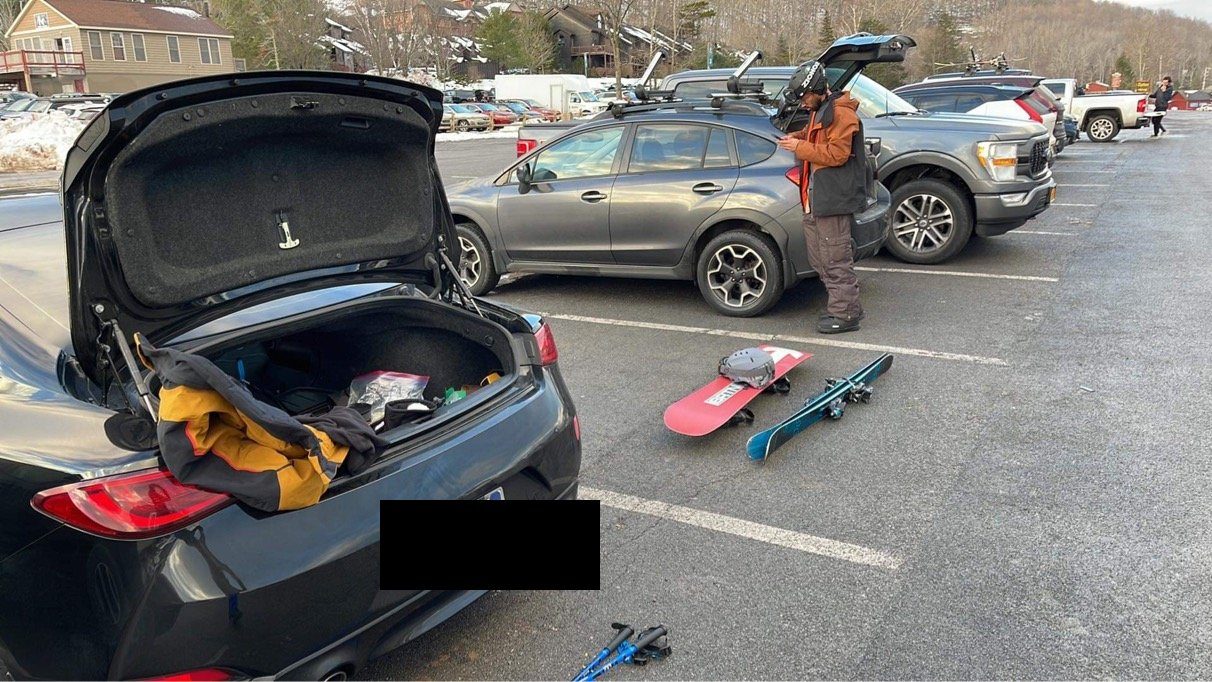 Subaru Crosstrek at ski resort parking lot with snowboard gear