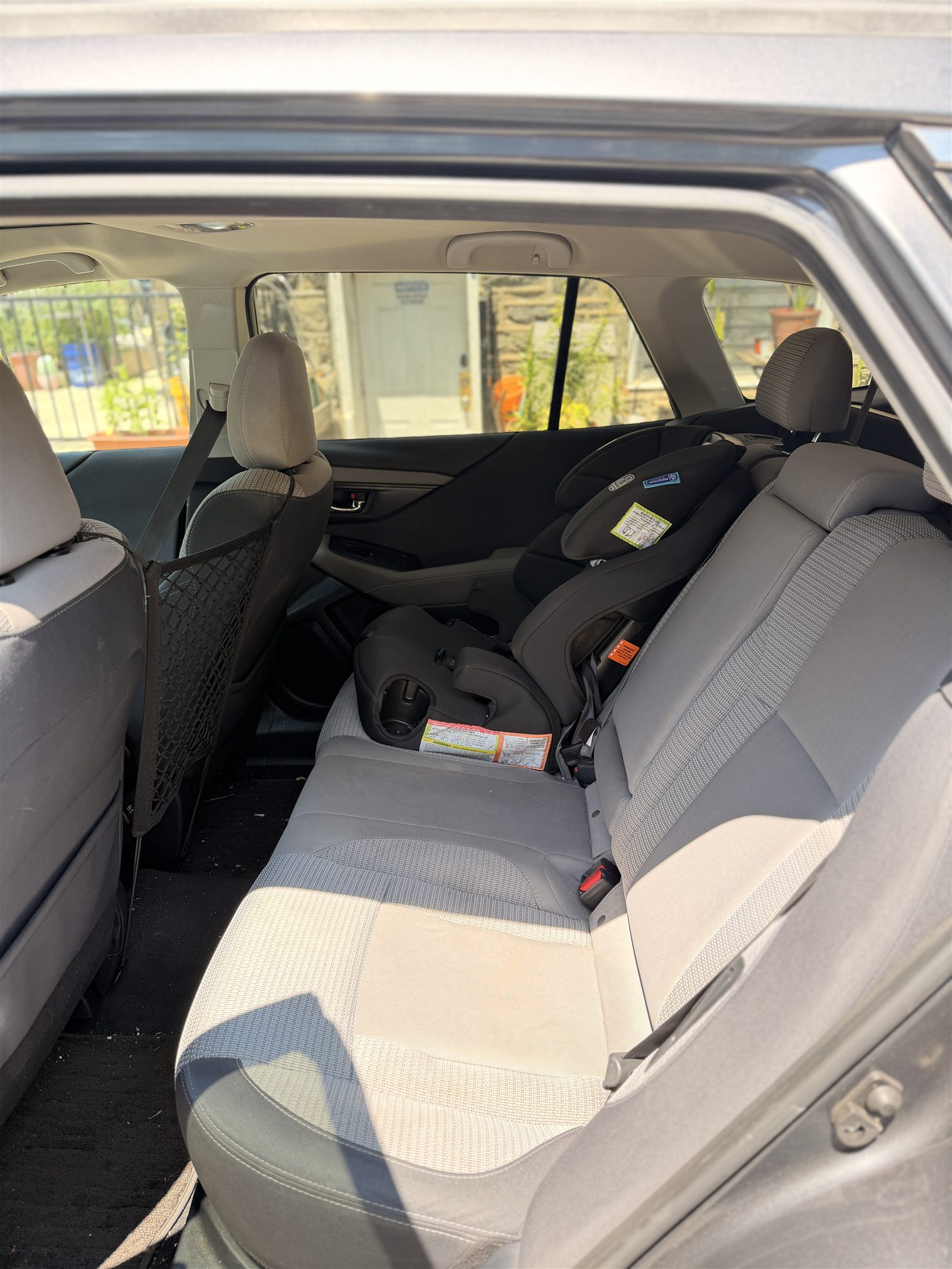 Installed child car seat in a Subaru Outback rear seat